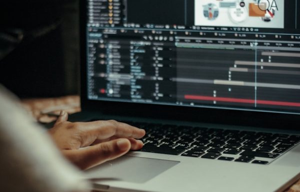 person using macbook pro on table